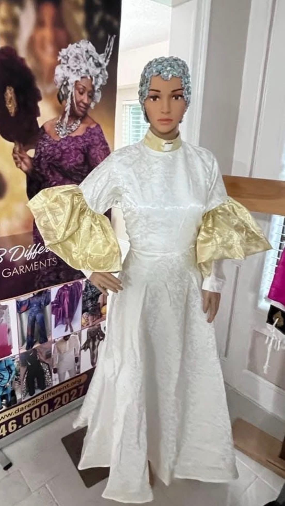 White brocade clergy robe with gold balloon sleeves and bejeweled cap, Houston Texas